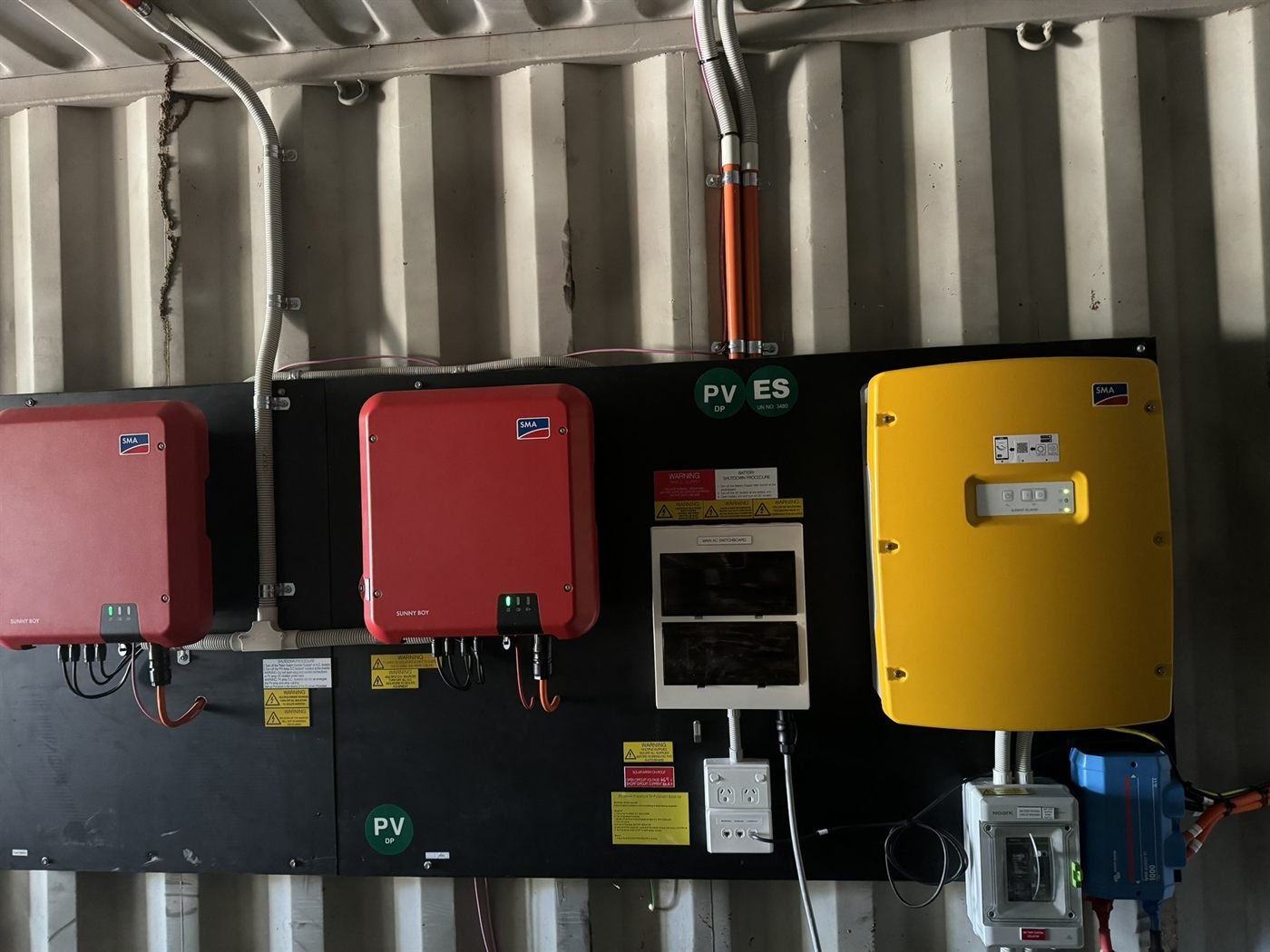 SMA Sunny Boy inverters with Victron auxiliary on an off-grid wall