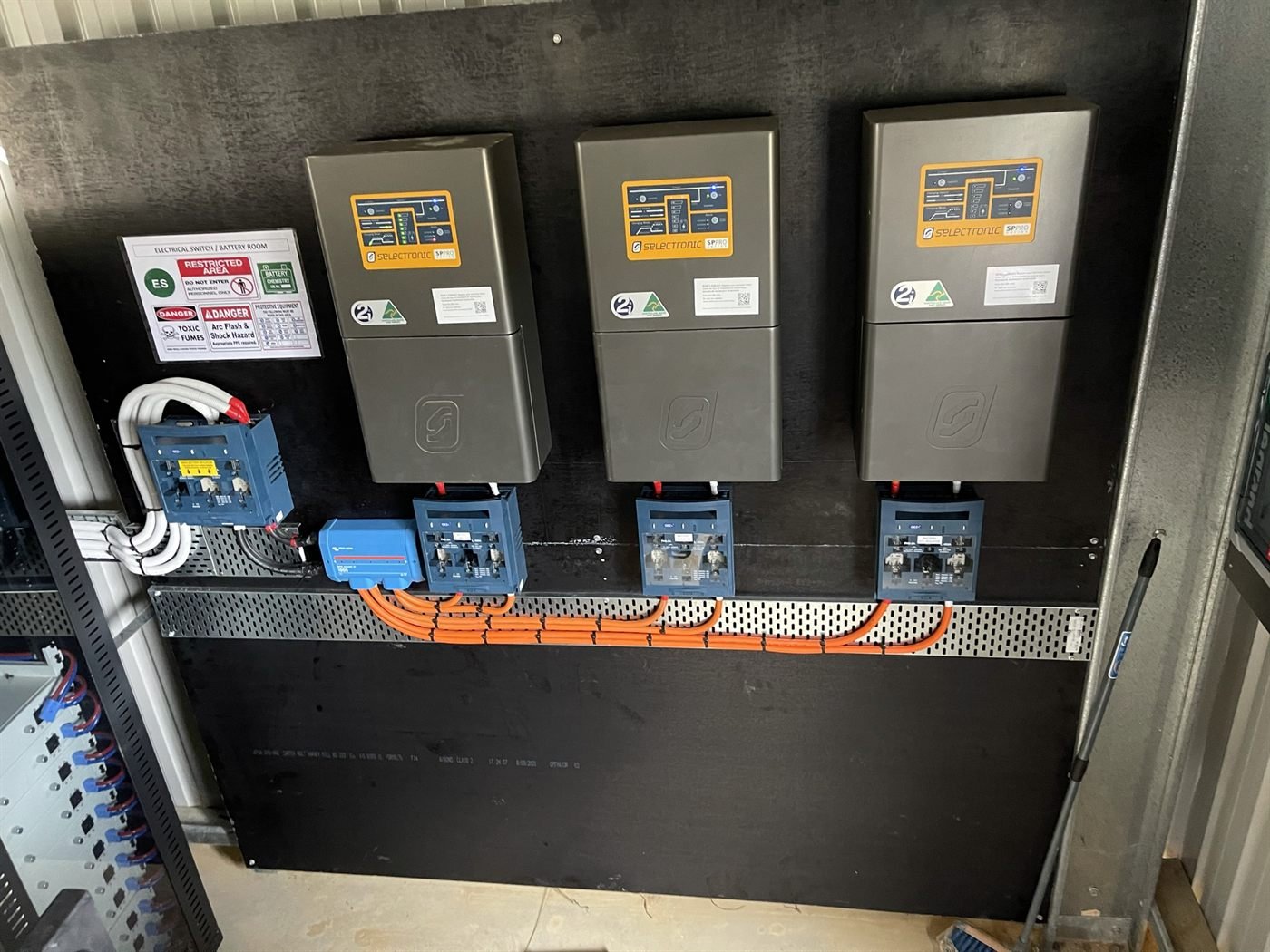 Multiple Selectronic SP PRO inverters in a wall-mounted bank