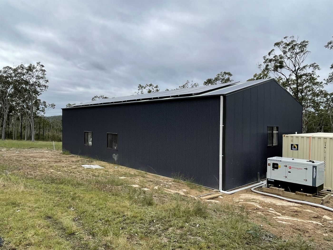 Off-grid shed with rooftop solar and a Himoinsa backup generator on bushland property