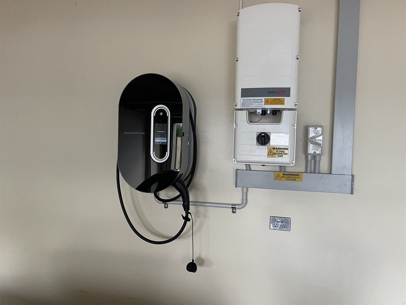 Porsche EV wall charger paired with a SolarEdge inverter on a Kemp Energy install