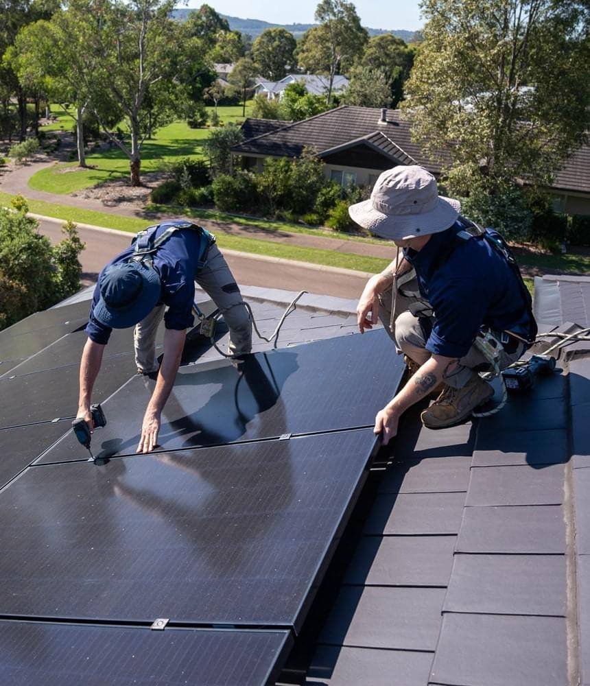 Two Kemp Energy installers fitting all-black solar panels to a tiled roof, Pokolbin NSW